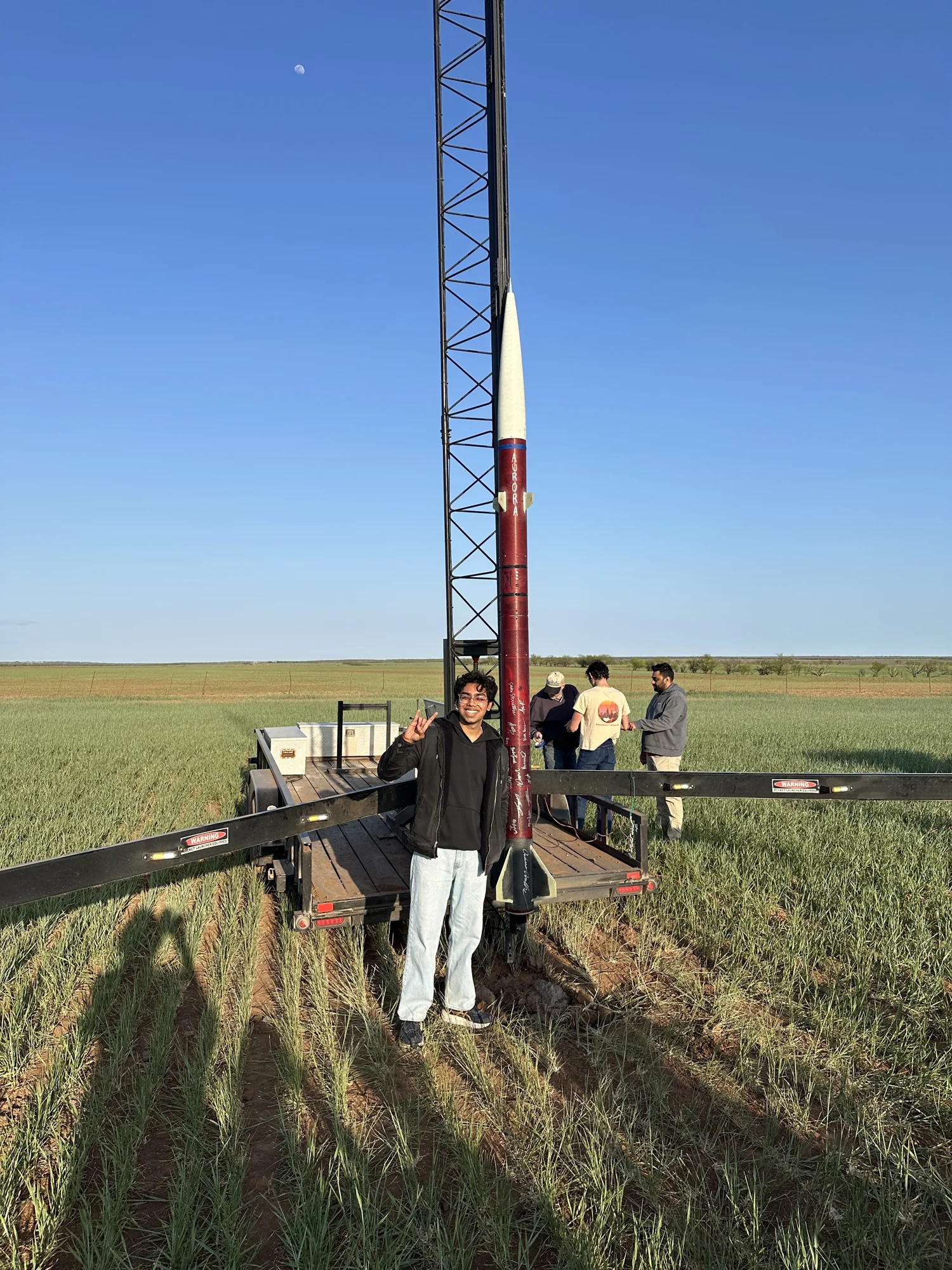 Om Chavan beside the Aurora rocket